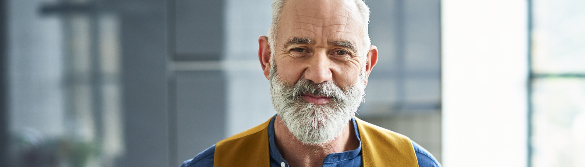 Man in blue shirt and vest.